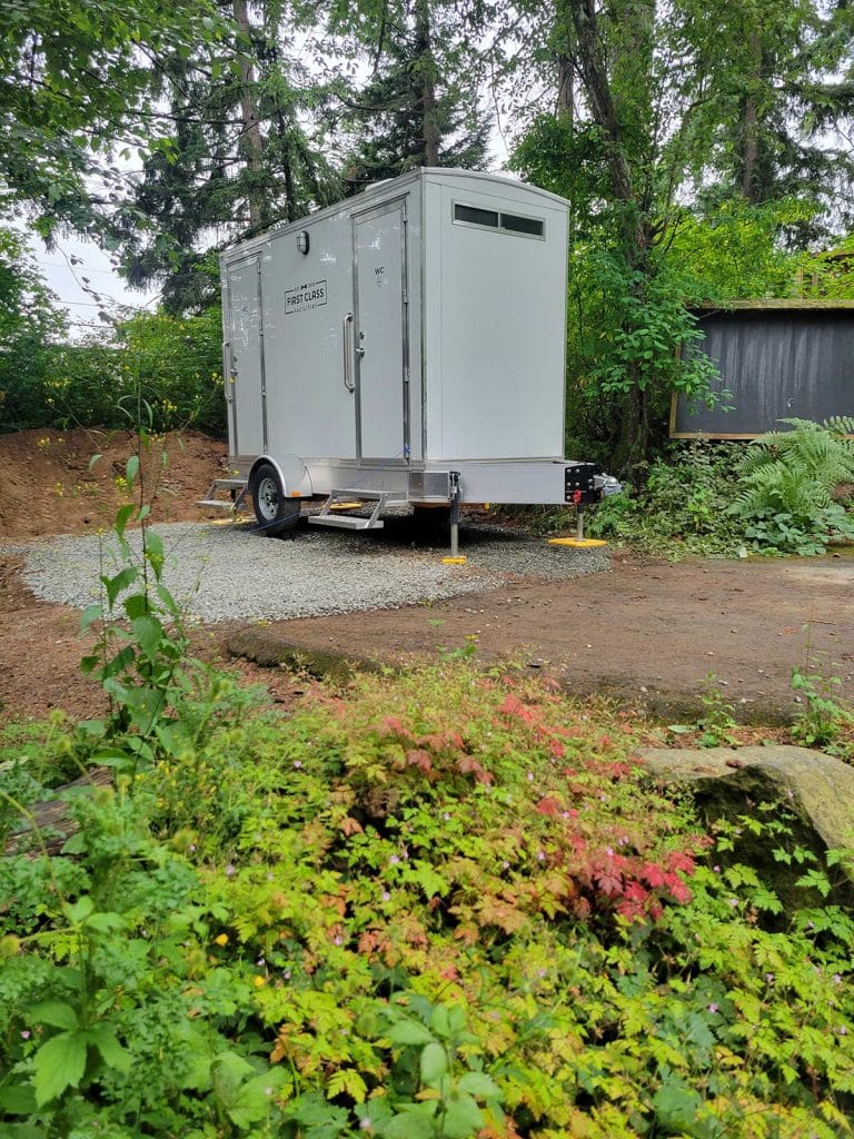 Portable restroom trailer in greenery