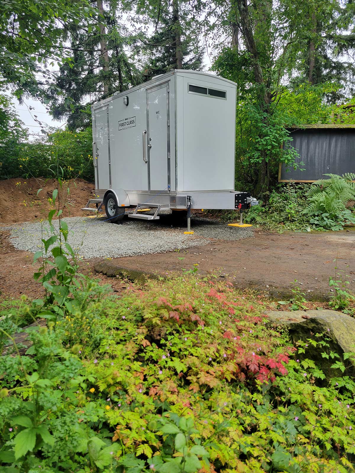 Portable restroom trailer in greenery