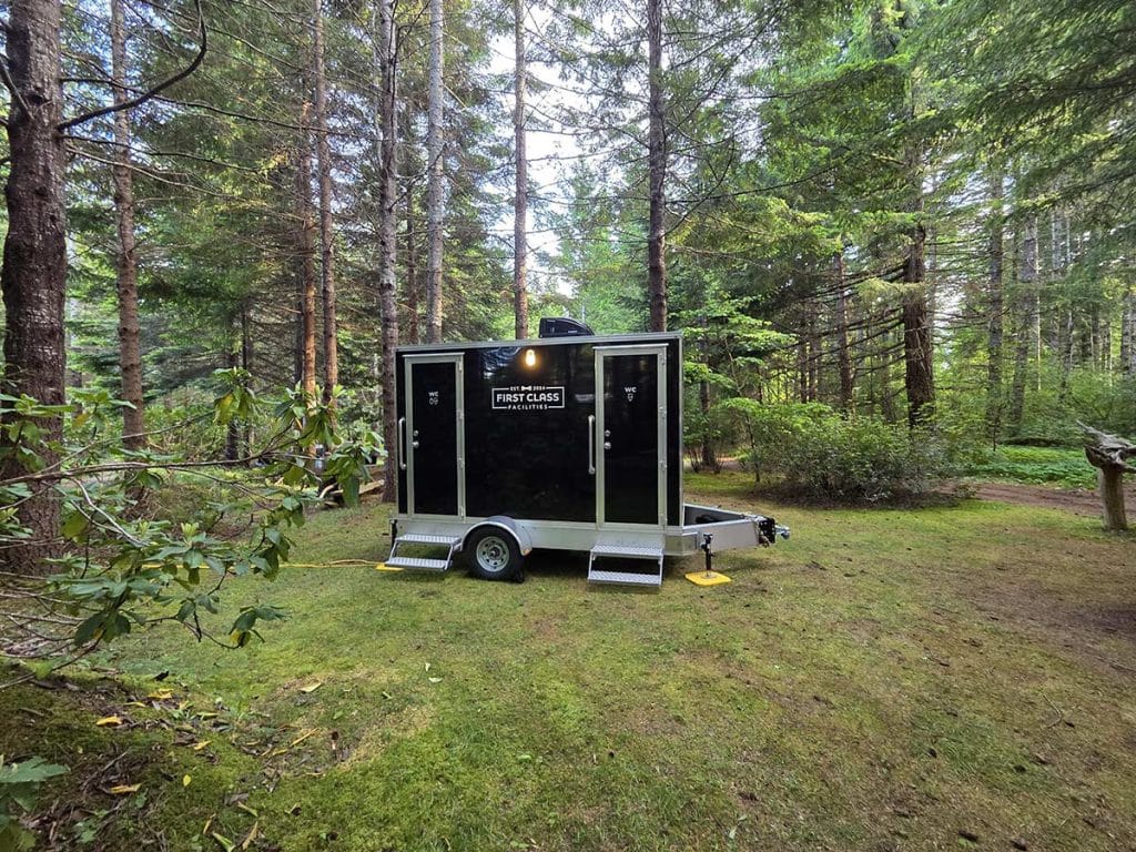 Portable restroom in forest setting