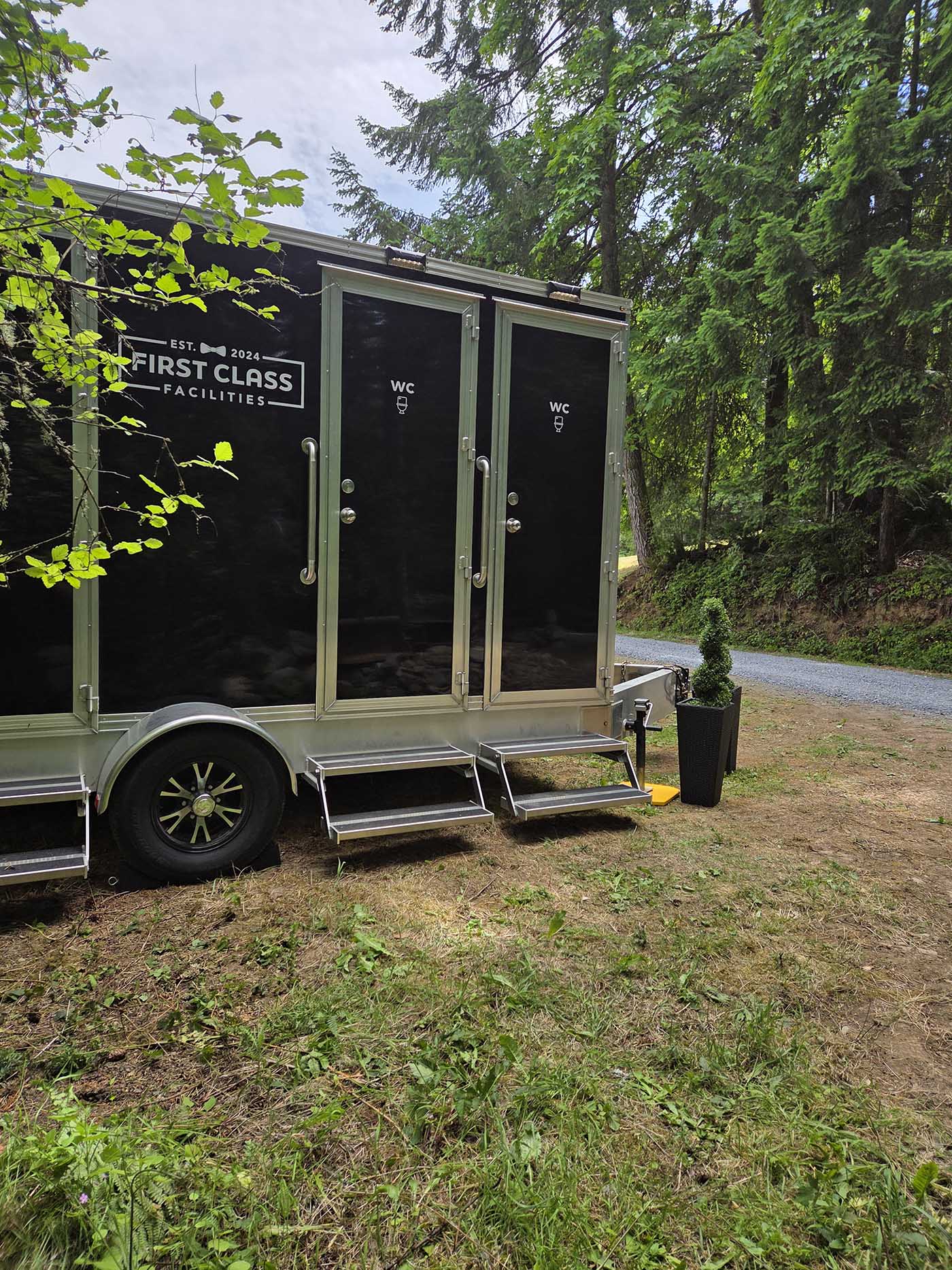 Portable restroom trailer in forested area
