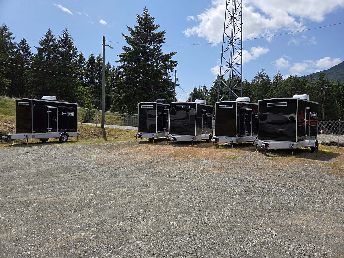 Row of black trailers in nature
