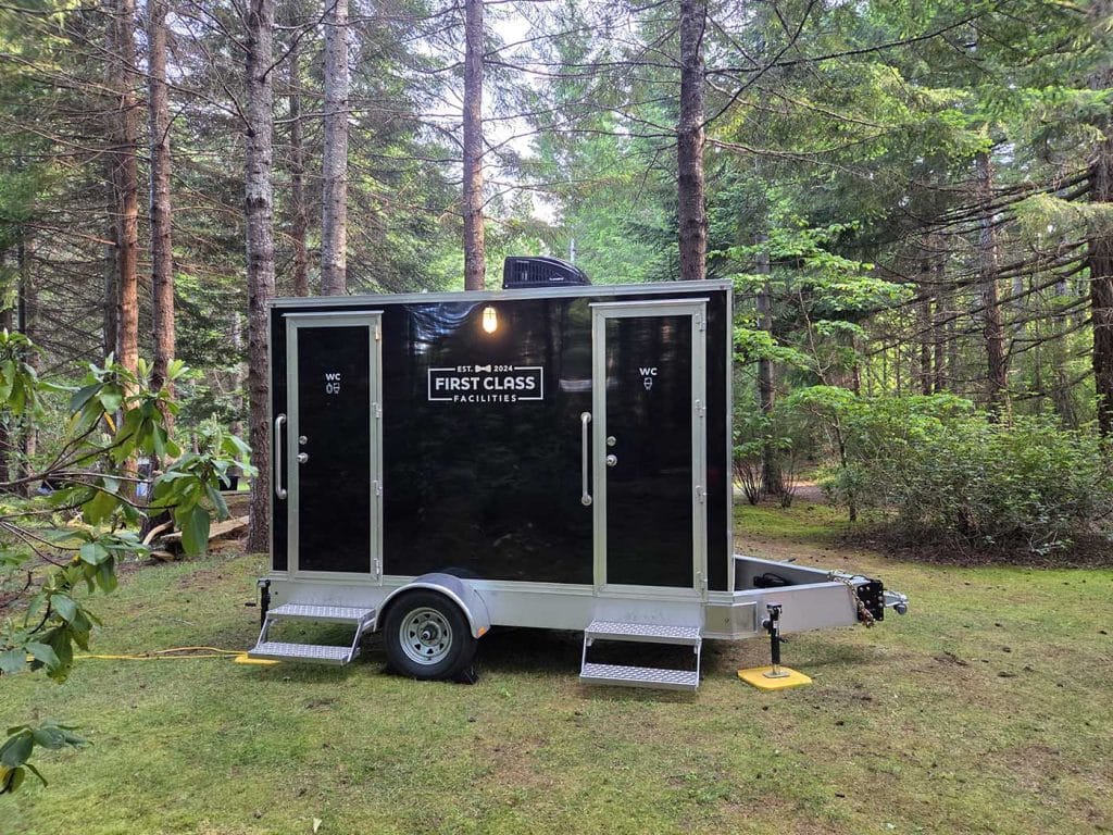 Portable restroom trailer in forested area