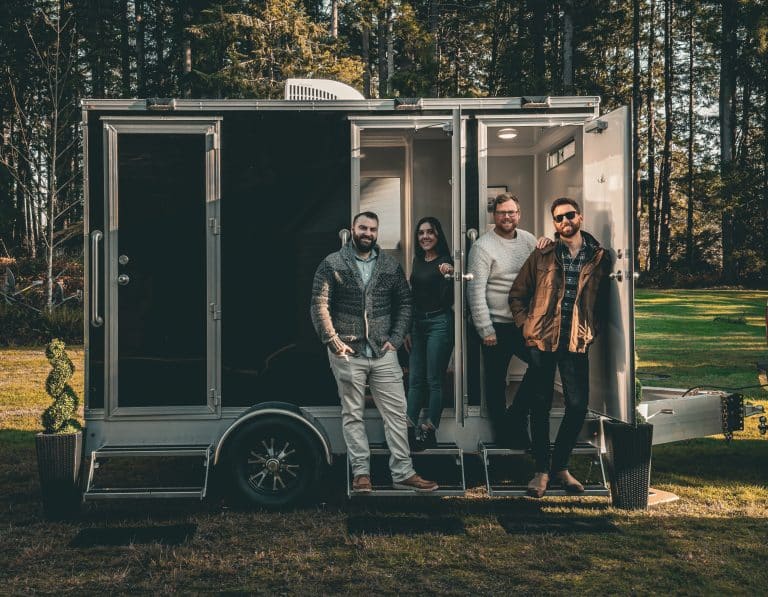 Group of people by a trailer.