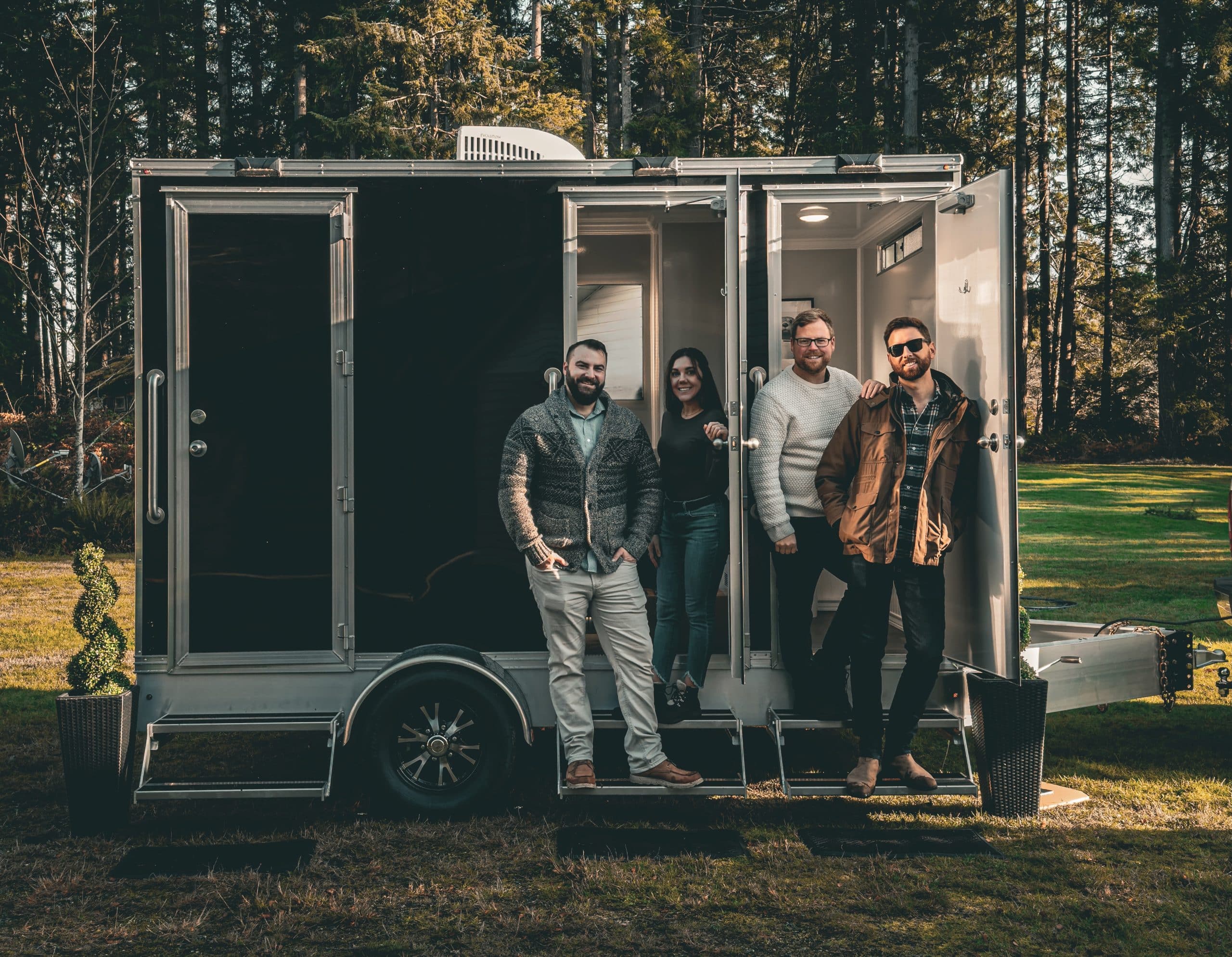 Group of people by a trailer.