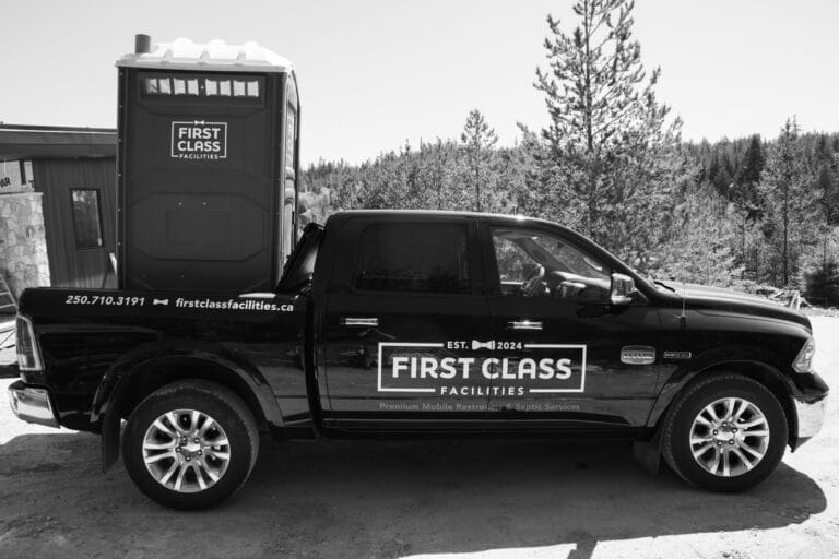 Truck with portable toilet in background
