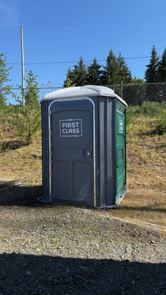 Portable toilet in outdoor setting.