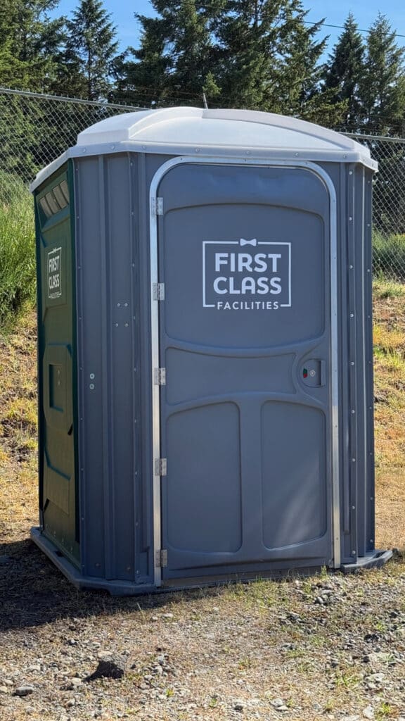 Portable toilet with First Class branding