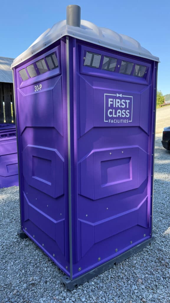 Purple portable toilet with branding.