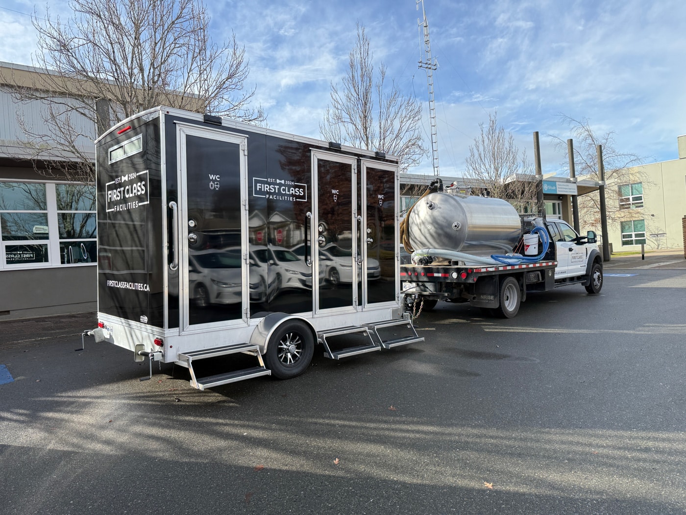Mobile restroom trailer parked with truck in Parksville, BC